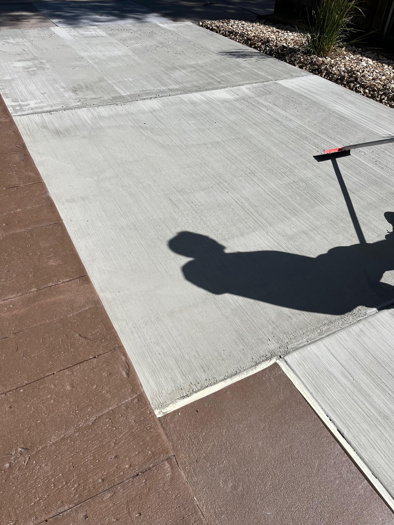 Applying broom finish concrete